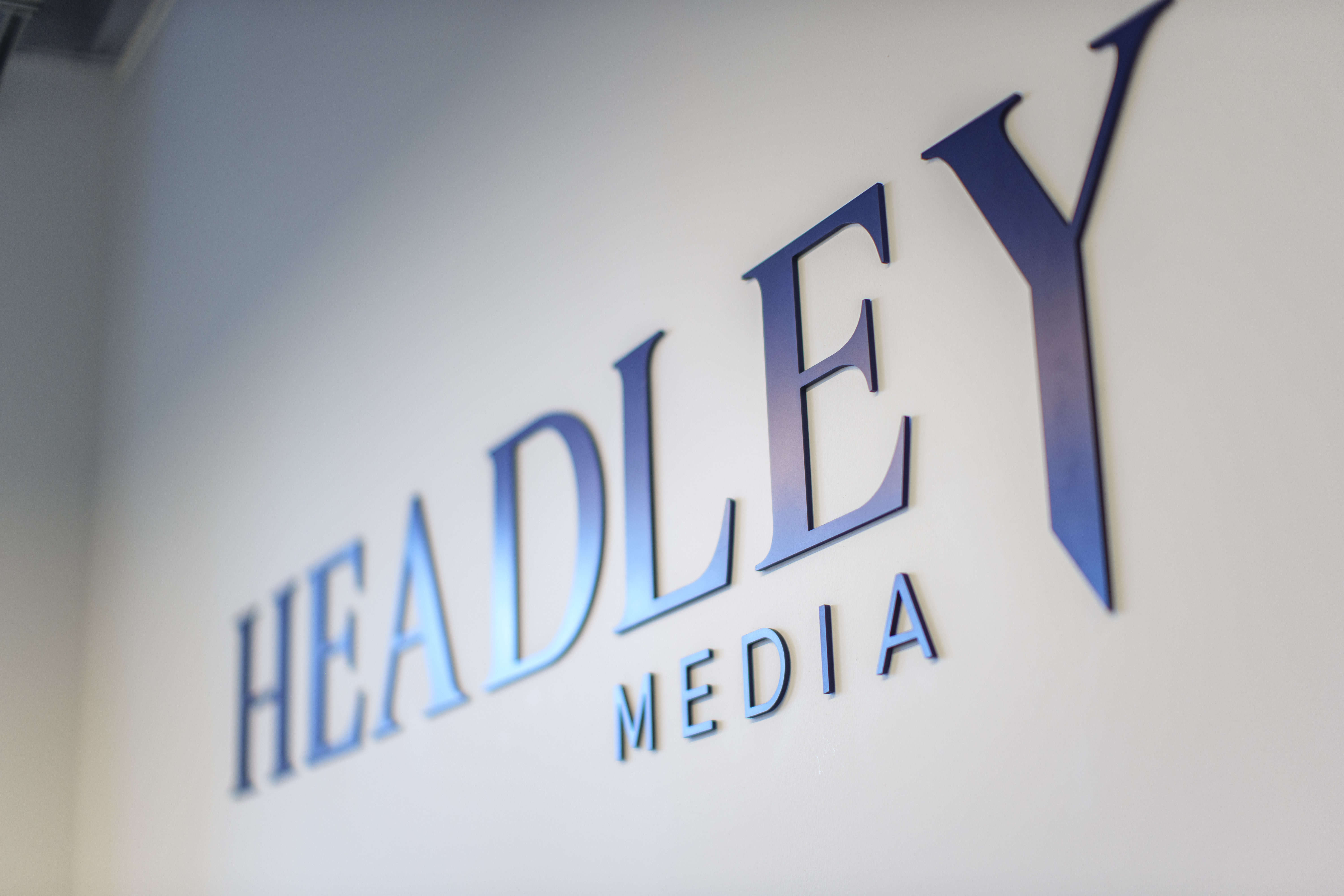 Headley Media logo on a white wall