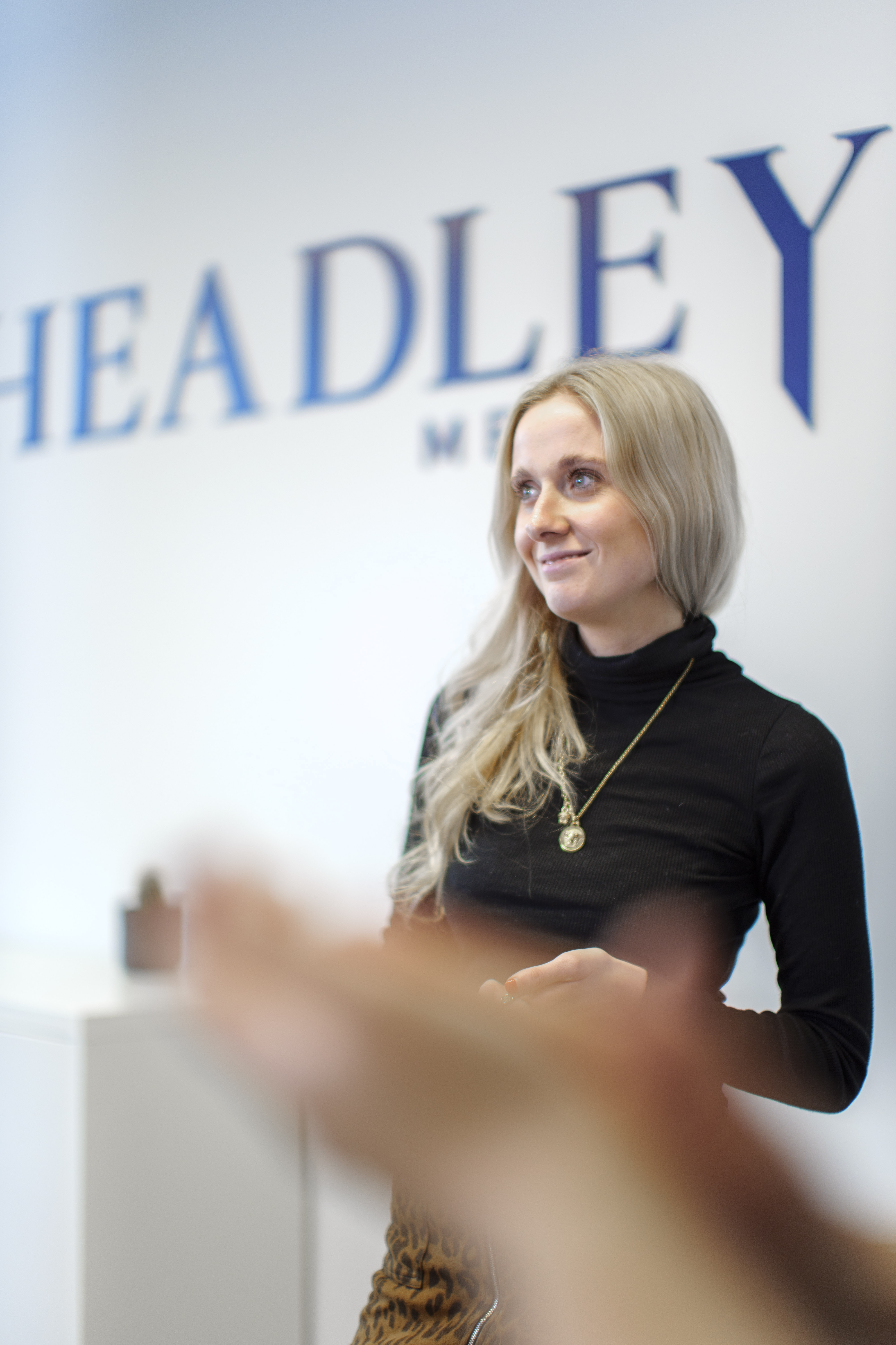 Headldey Media colleague standing up in the office