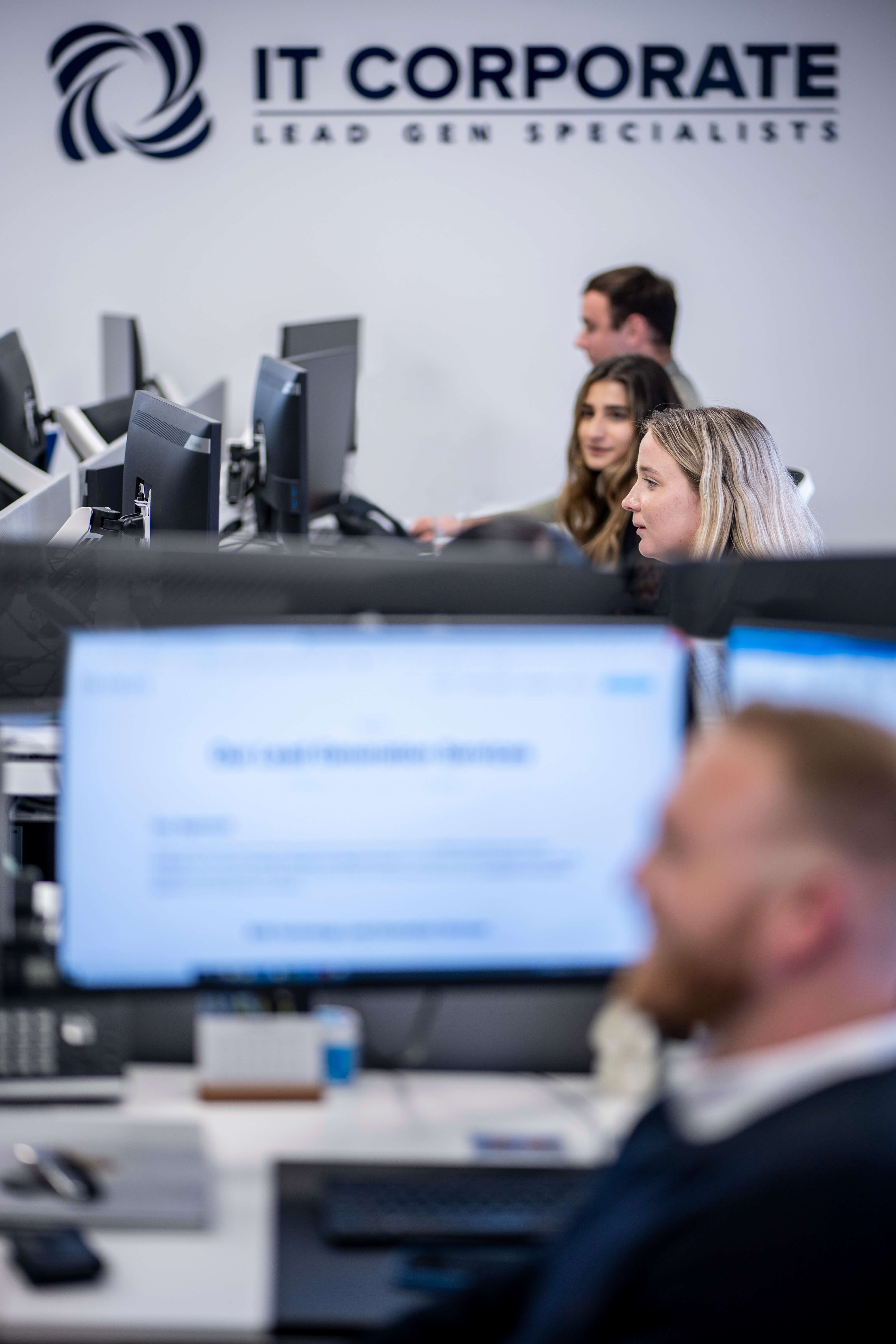 Photo of Headley Media colleagues with IT Corporate sign in the background.